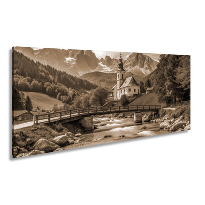 Leinwandbild Alpenidylle mit Kirche, Brücke und türkisblauem Bach. - deyoli