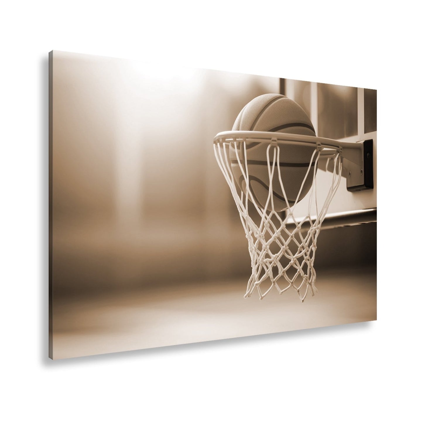 Leinwandbild Basketball versinkt elegant im Korb im sanften Licht. - deyoli