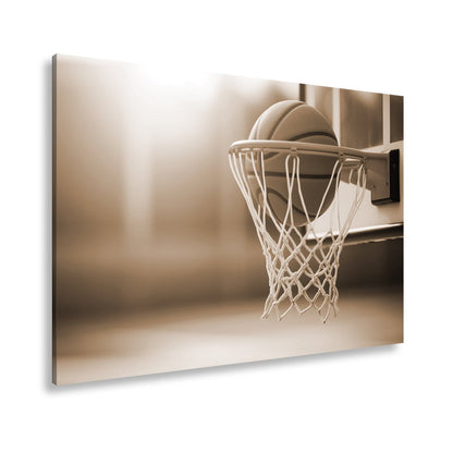 Leinwandbild Basketball versinkt elegant im Korb im sanften Licht. - deyoli