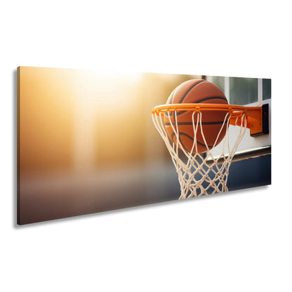 Leinwandbild Basketball versinkt elegant im Korb im sanften Licht. - deyoli