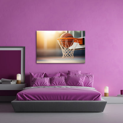 Leinwandbild Basketball versinkt elegant im Korb im sanften Licht. - deyoli
