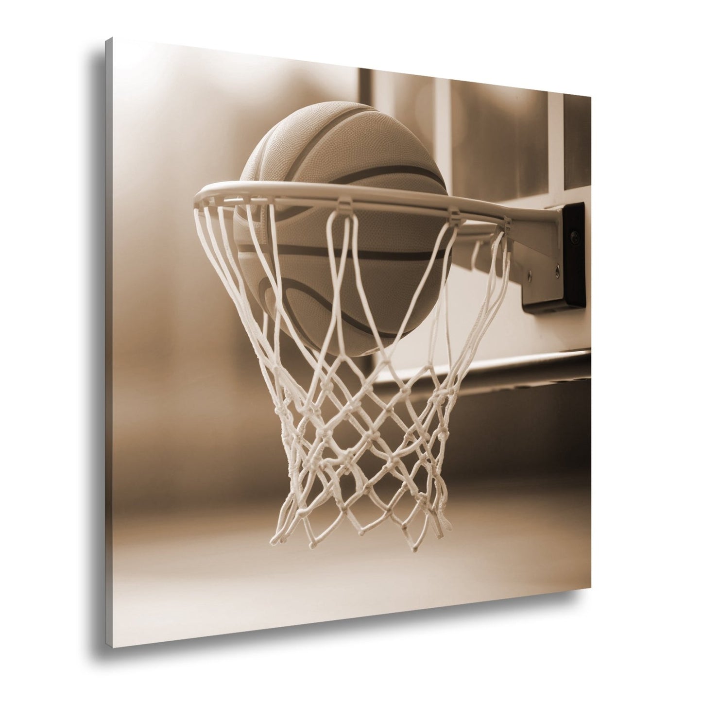Leinwandbild Basketball versinkt elegant im Korb im sanften Licht. - deyoli