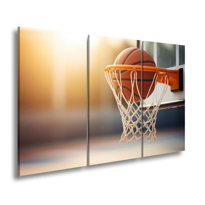 Leinwandbild Basketball versinkt elegant im Korb im sanften Licht. - deyoli