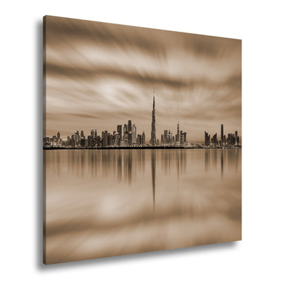 Leinwandbild Dubai XXL – Skyline spiegelt im glühenden Abendhimmel - deyoli