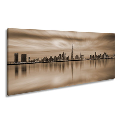 Leinwandbild Dubai XXL – Skyline spiegelt im glühenden Abendhimmel - deyoli