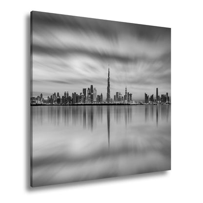 Leinwandbild Dubai XXL – Skyline spiegelt im glühenden Abendhimmel - deyoli
