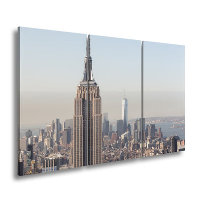 Leinwandbild Empire State thront klar über einer hellen skyline am ruhigen Morgen - deyoli
