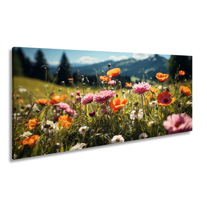 Leinwandbild Farbenfrohe Wiesenblumen tanzen vor Bergkulisse. - deyoli