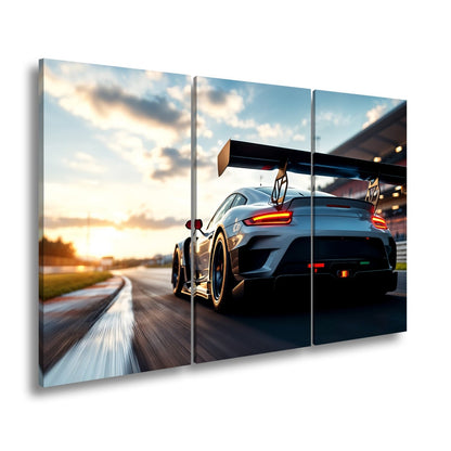 Leinwandbild Flügel aus Carbon rasen ins goldene Licht XXL – Auto Rennstrecke - deyoli