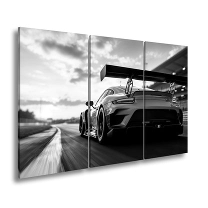 Leinwandbild Flügel aus Carbon rasen ins goldene Licht XXL – Auto Rennstrecke - deyoli