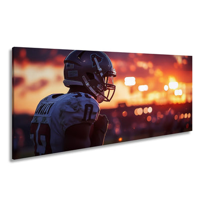 Leinwandbild Footballer im Sonnenuntergang – Fokus im letzten Licht. - deyoli