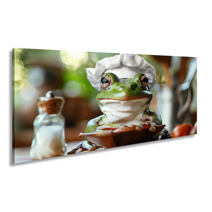 Leinwandbild Frosch mit Kochmütze – stiller Gourmet am Werk. - deyoli