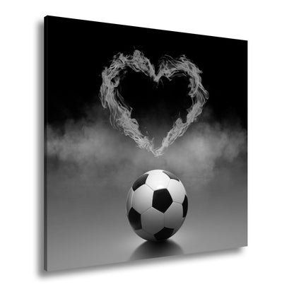 Leinwandbild Fußballliebe brennt – Herz aus Flammen über dem Spielball. - deyoli