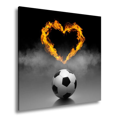 Leinwandbild Fußballliebe brennt – Herz aus Flammen über dem Spielball. - deyoli
