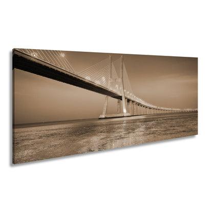 Leinwandbild Goldenes Leuchten über Brücke bei ruhigem Abendmeer XXL – Landschaft - deyoli