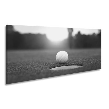 Leinwandbild Golfball vor dem Ziel – Spannung im Licht des Sonnenuntergangs - deyoli