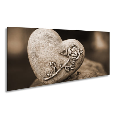 Leinwandbild Herz aus Stein – verziert mit einer Rose der Erinnerung. - deyoli