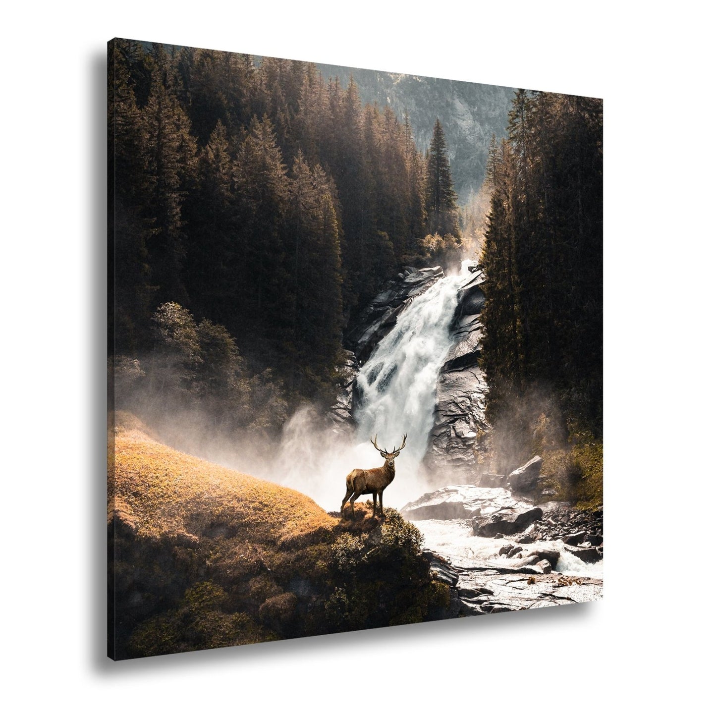Leinwandbild Hirsch vor tosender Wasserfallkulisse - deyoli