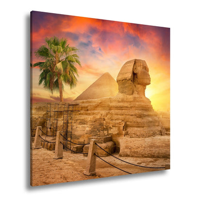 Leinwandbild Im Glanz der Sonne – die Sphinx ruht vor ägyptischer Pracht. - deyoli