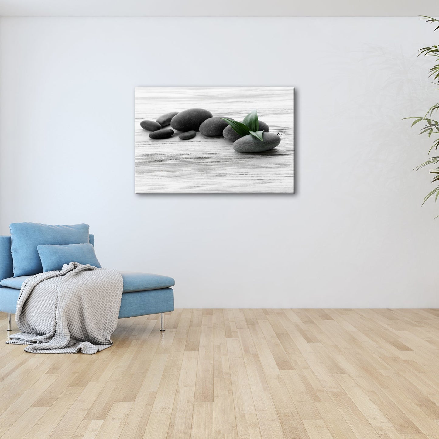 Leinwandbild Schwarze Steine, grünes Blatt – Ruhe auf weißem Holz. - deyoli