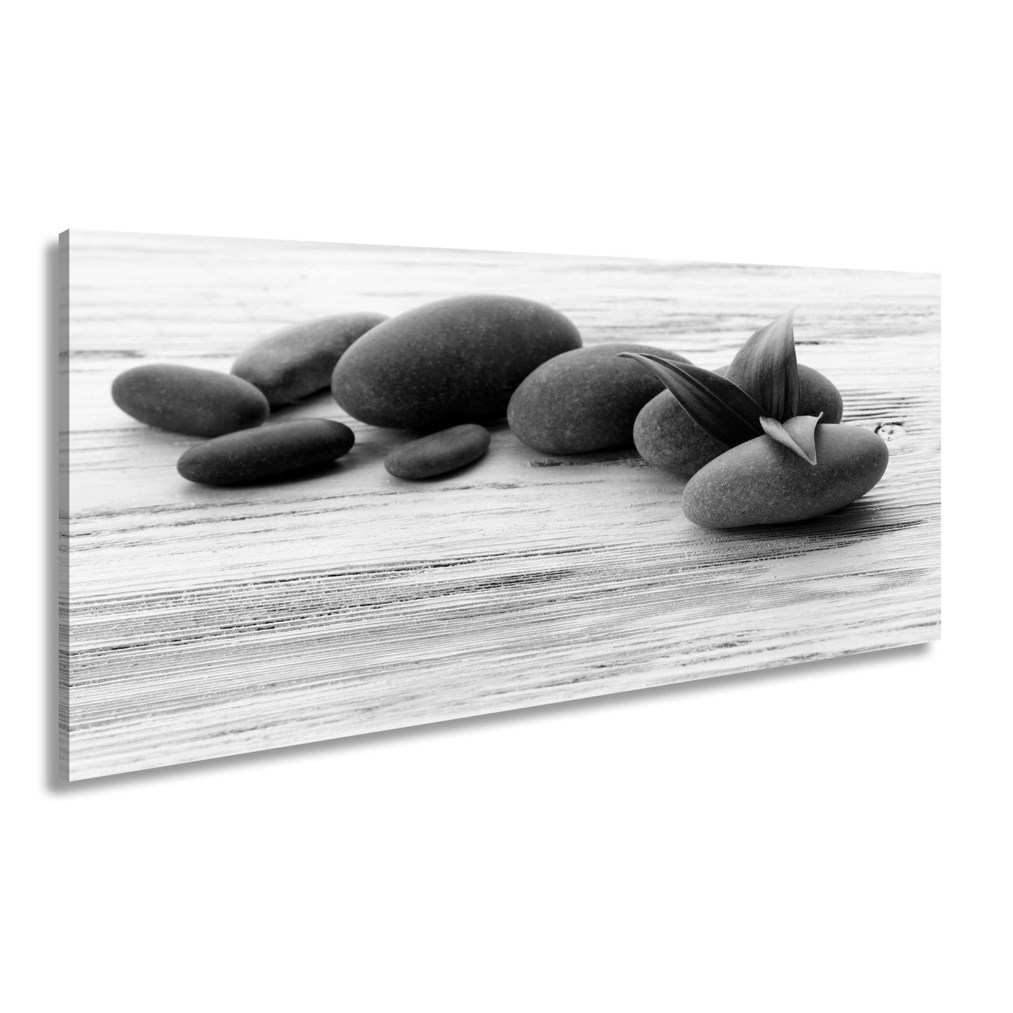 Leinwandbild Schwarze Steine, grünes Blatt – Ruhe auf weißem Holz. - deyoli