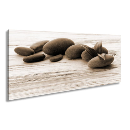 Leinwandbild Schwarze Steine, grünes Blatt – Ruhe auf weißem Holz. - deyoli