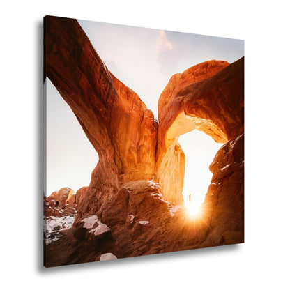 Leinwandbild Sonnenaufgang durch majestätische Felsbögen – Natur XXL - deyoli