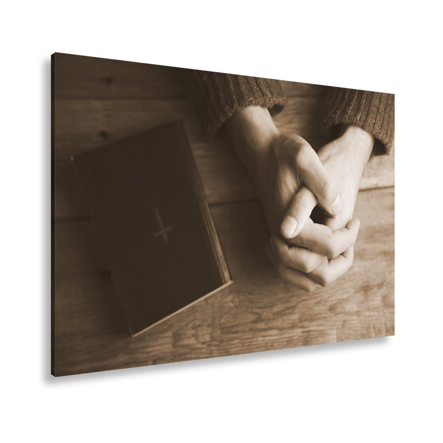 Leinwandbild Verborgene Hände ruhen betend neben einem schlichten Buch - deyoli