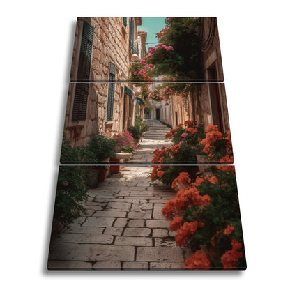Leinwandbild Verwunschene Gasse voller Blütenpracht und mediterranem Charme - deyoli