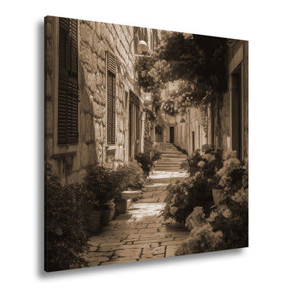 Leinwandbild Verwunschene Gasse voller Blütenpracht und mediterranem Charme - deyoli