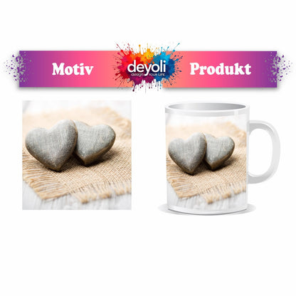 Motivtasse Zwei Steinherzen ruhen auf sanftem Leinengewebe. - deyoli